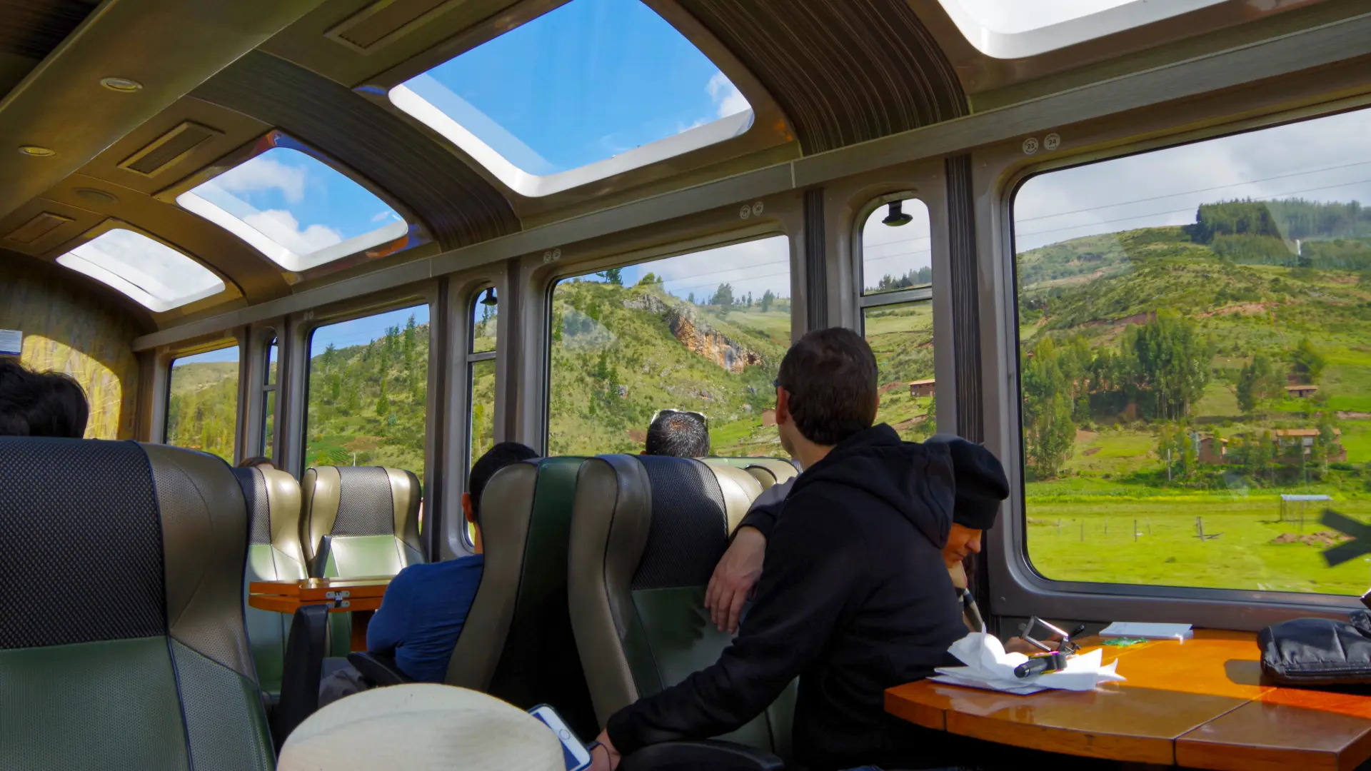 Train ride with panoramic windows during a Machu Picchu day trip from Cusco, showcasing the scenic Andean landscape.